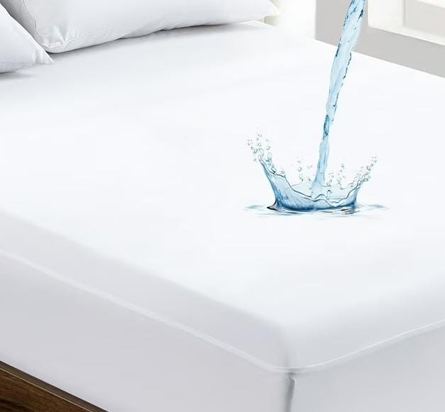 A white waterproof mattress pad with a water splash effect, highlighting one of the best mattress pads for protection against spills and stains.